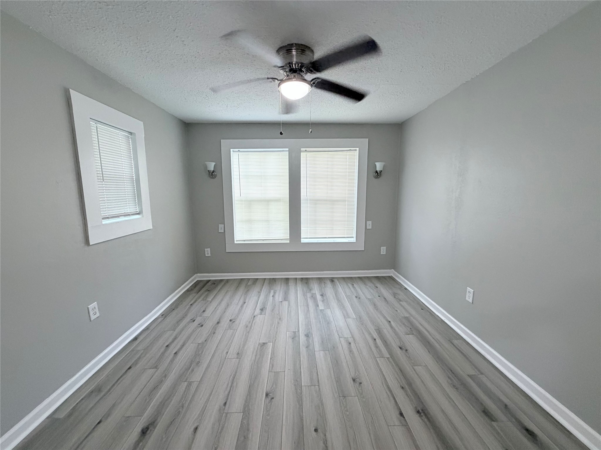 1903 Little Street La Marque, TX 77568 - Photo 16 of 18 wooden floor in an empty room with a window