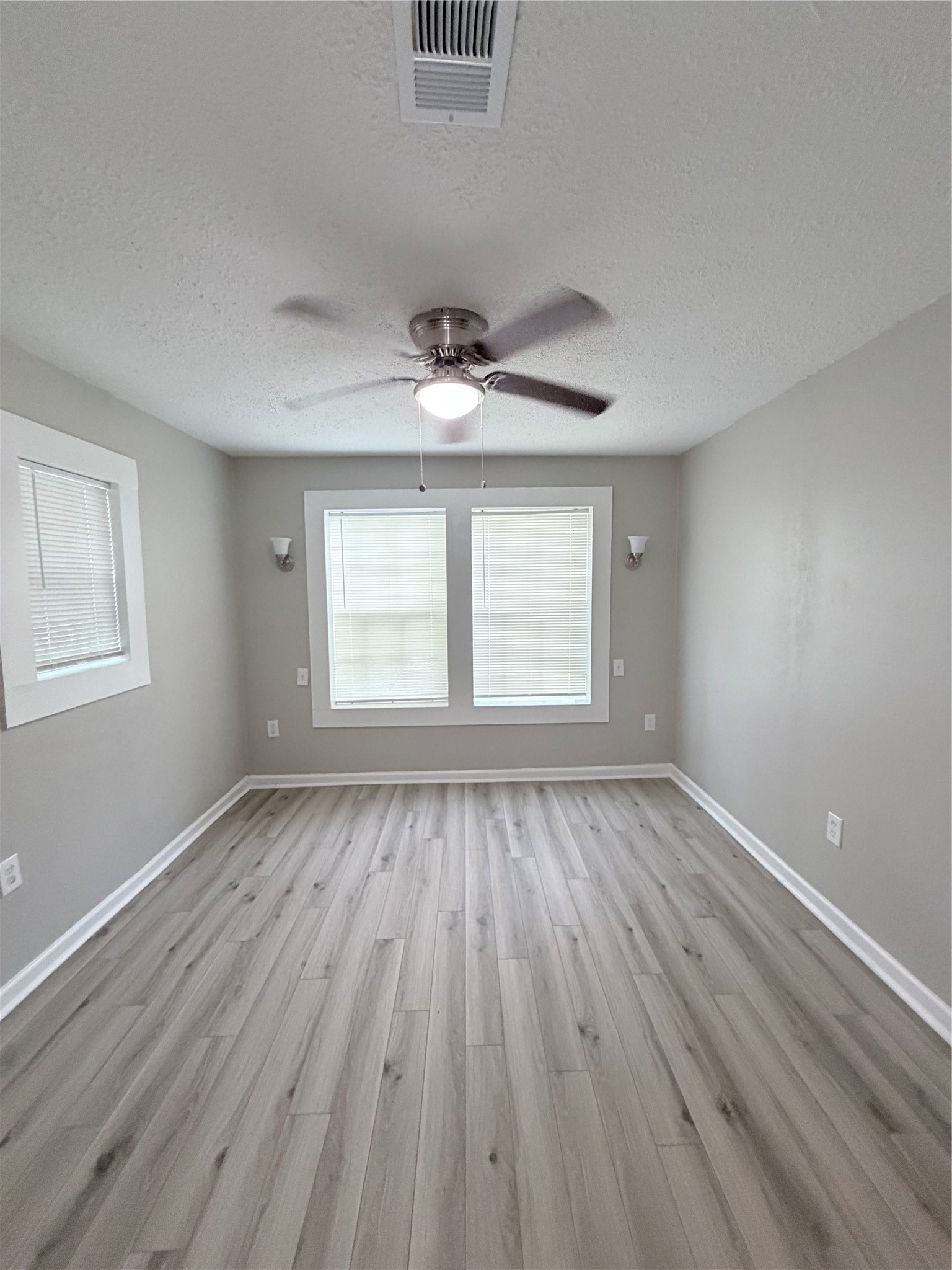1903 Little Street La Marque, TX 77568 - Photo 17 of 18 wooden floor in an empty room with a window