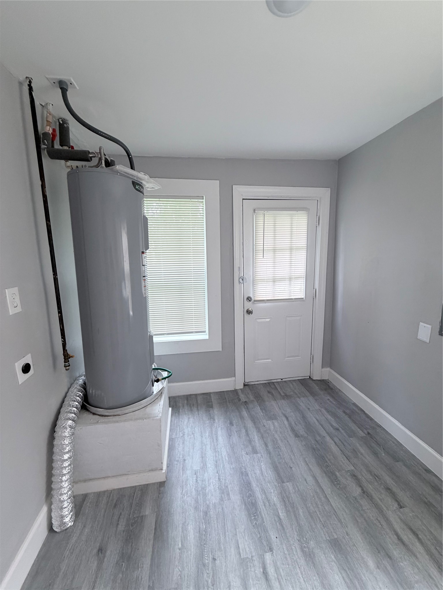 1903 Little Street La Marque, TX 77568 - Photo 18 of 18 wooden floor in an empty room with a window