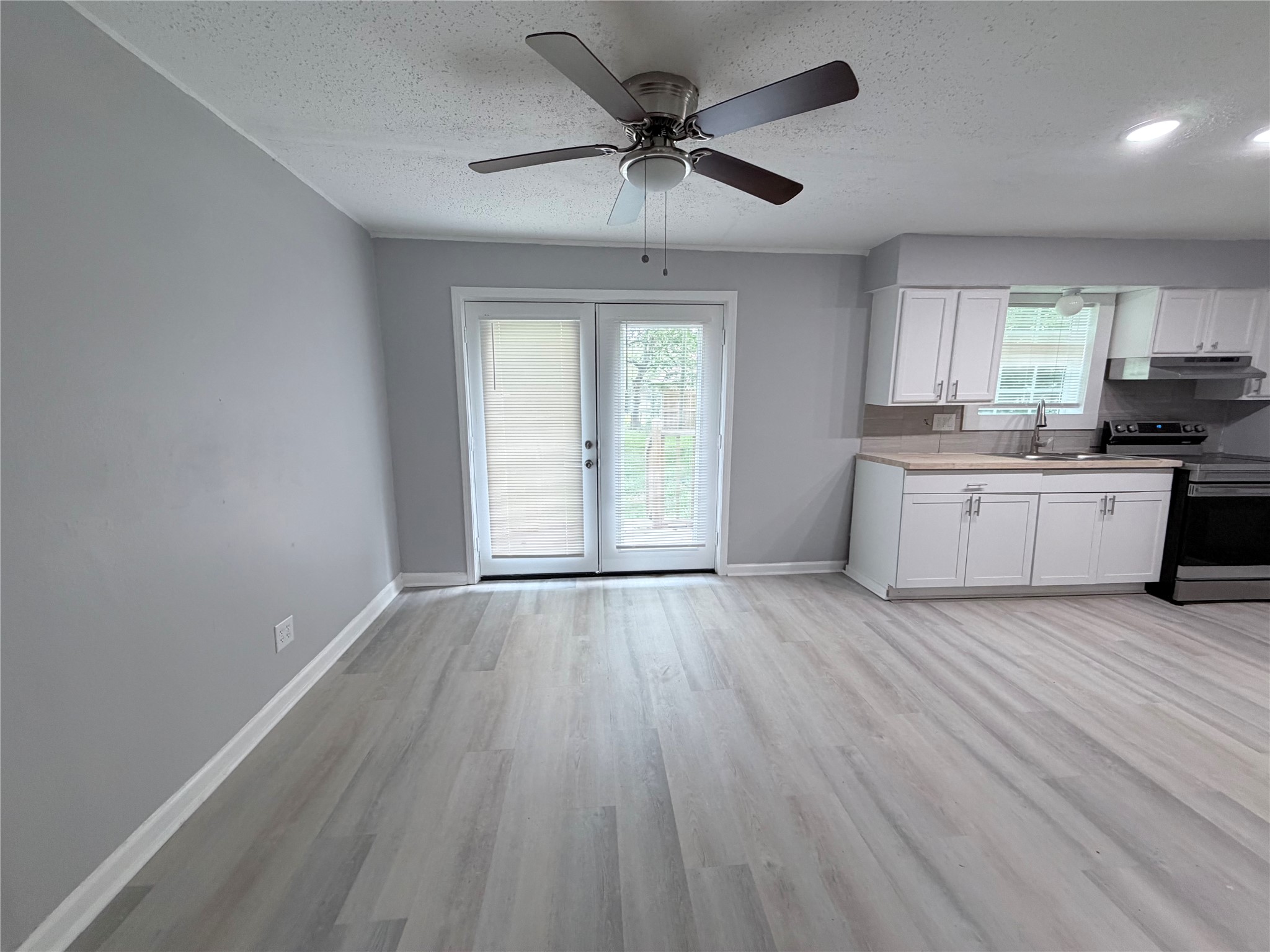 1903 Little Street La Marque, TX 77568 - Photo 6 of 18 a view of a kitchen with a sink and dishwasher with wooden floor