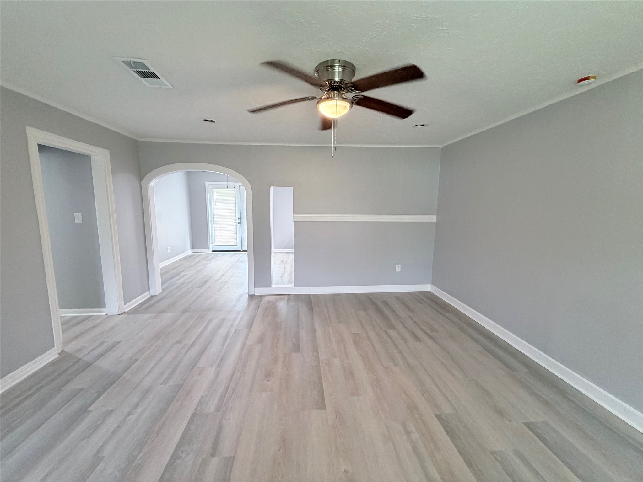 1903 Little Street La Marque, TX 77568 - Photo 9 of 18 a view of empty room with wooden floor and fan