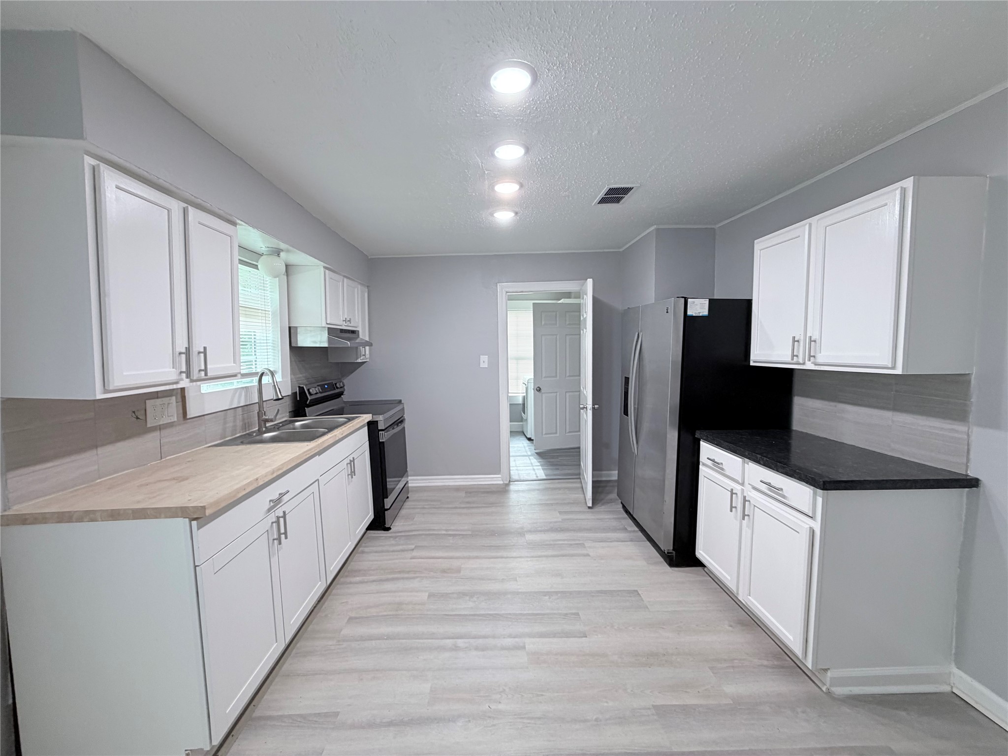 1903 Little Street La Marque, TX 77568 - Photo 10 of 18 a kitchen with a sink a counter top space and stainless steel appliances