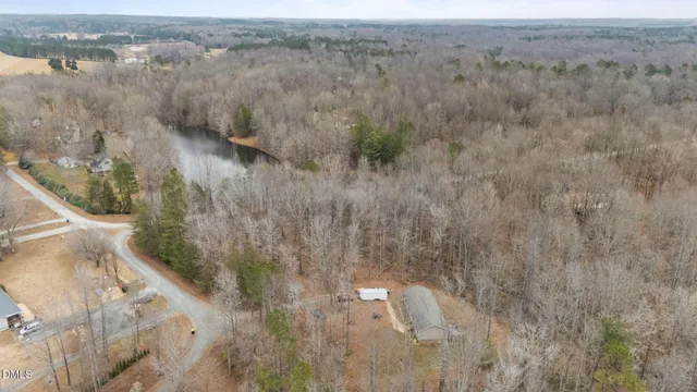 a backyard of a house with large trees and outdoor space