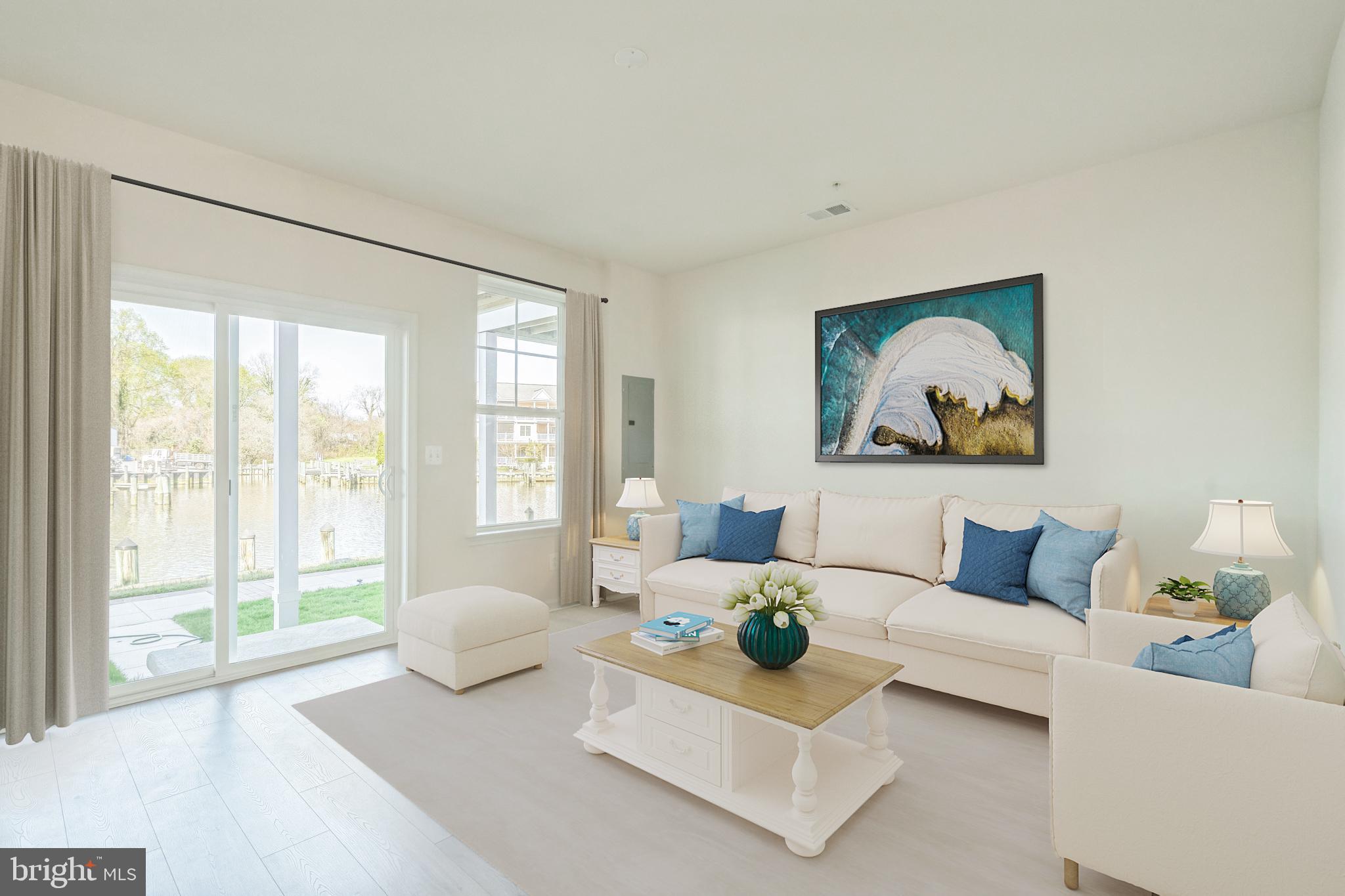 20 Riverside Drive Cambridge, MD 21613 - Photo 6 of 17 a living room with furniture and a large window with garden view