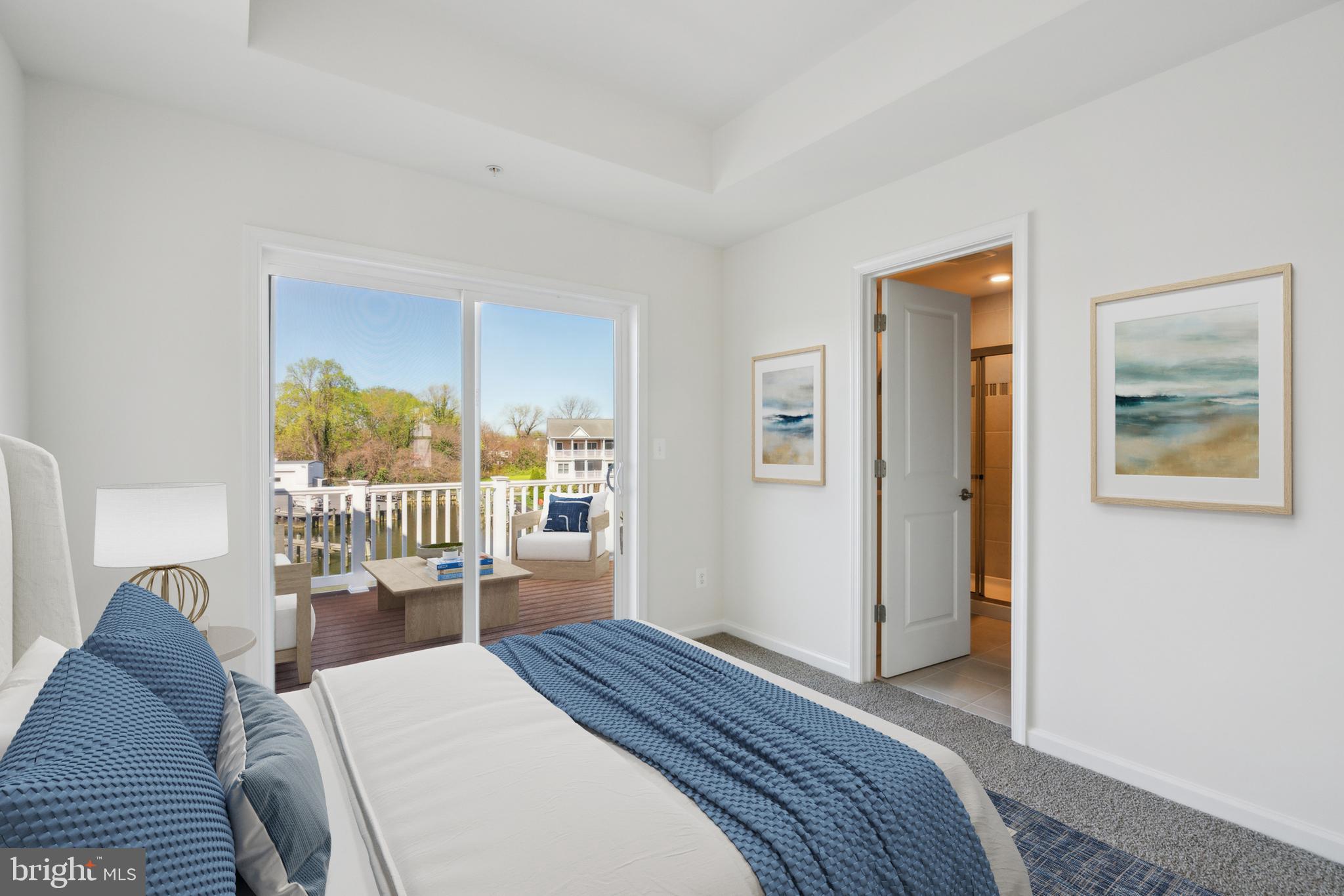 20 Riverside Drive Cambridge, MD 21613 - Photo 8 of 17 a bedroom with a bed and a window with chair