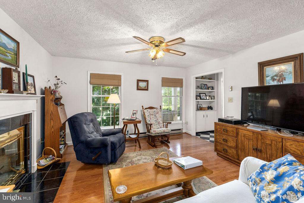 1115 Chapel Road Middletown, VA 22645 - Photo 19 of 54 a living room with furniture a fireplace and a flat screen tv