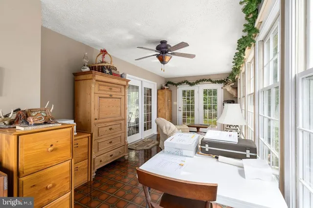 a kitchen with stainless steel appliances a stove a sink dishwasher and white cabinets with wooden floor