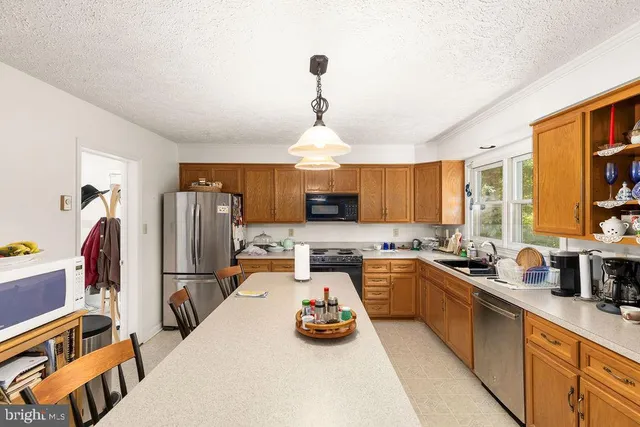 a kitchen with a stove a sink and a microwave