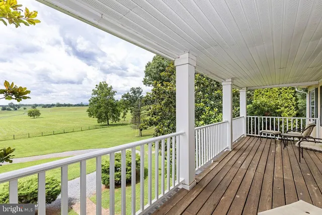 a view of balcony with wooden floor and iron stairs