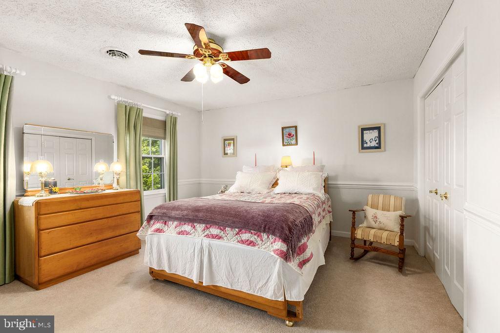 1115 Chapel Road Middletown, VA 22645 - Photo 39 of 54 a bedroom with a bed and a chandelier