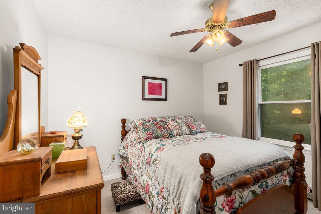 1115 Chapel Road Middletown, VA 22645 - Photo 40 of 54 a bedroom with a bed and a chandelier