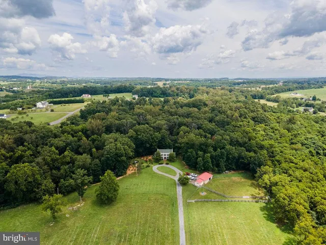 an aerial view of a house with a yard and garden