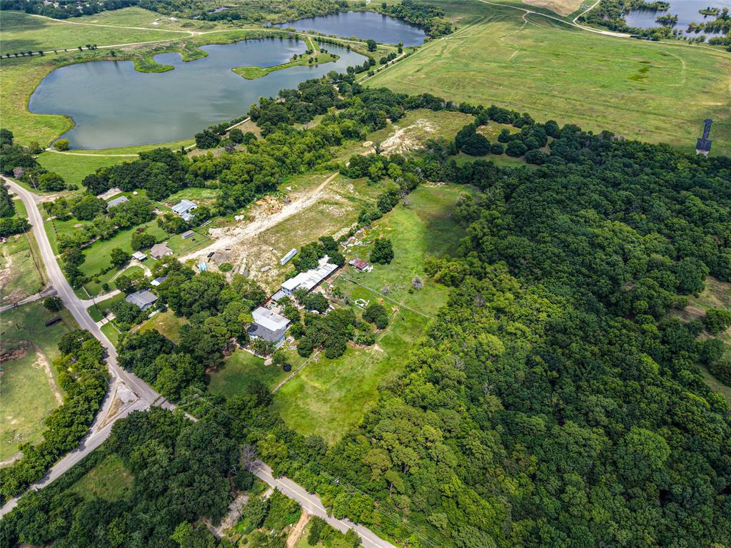 1900 Haymarket Road Dallas, TX 75253 - Photo 14 of 20 Aerial perspective showcasing expansive green spaces, mature tree coverage, and a substantial body of water