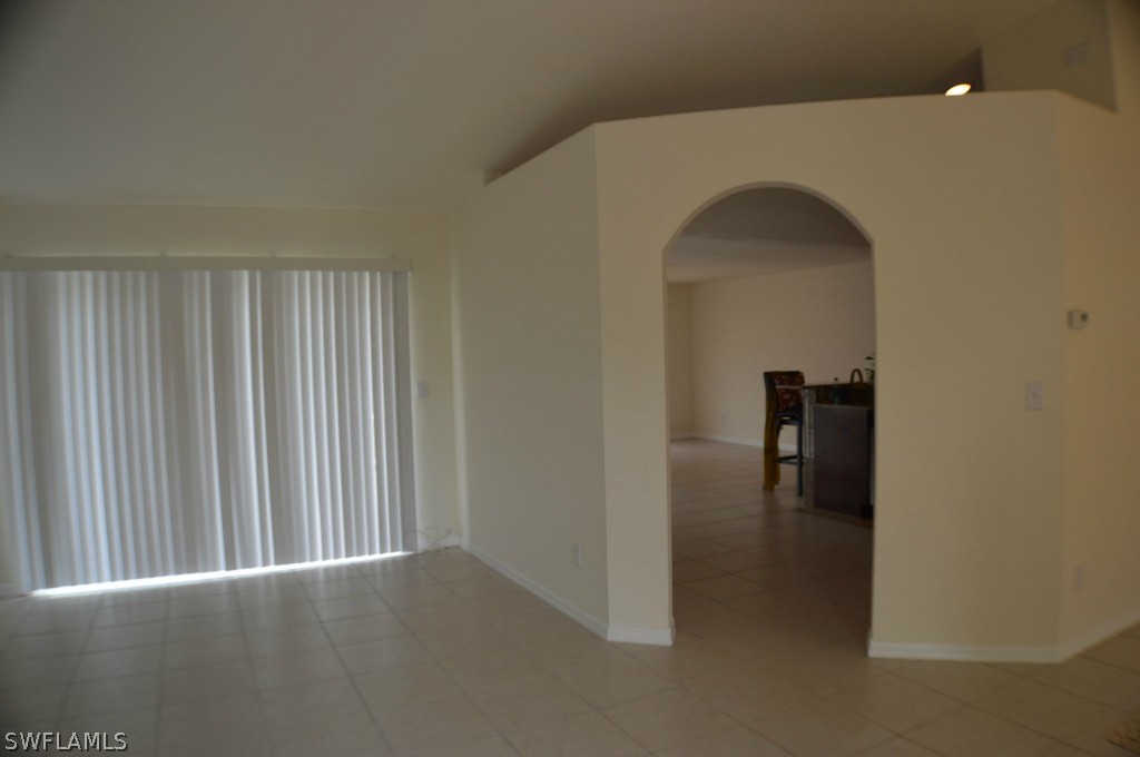 134 Ridgemont Drive Lehigh Acres, FL 33972 - Photo 3 of 14 a view of a hallway with a room