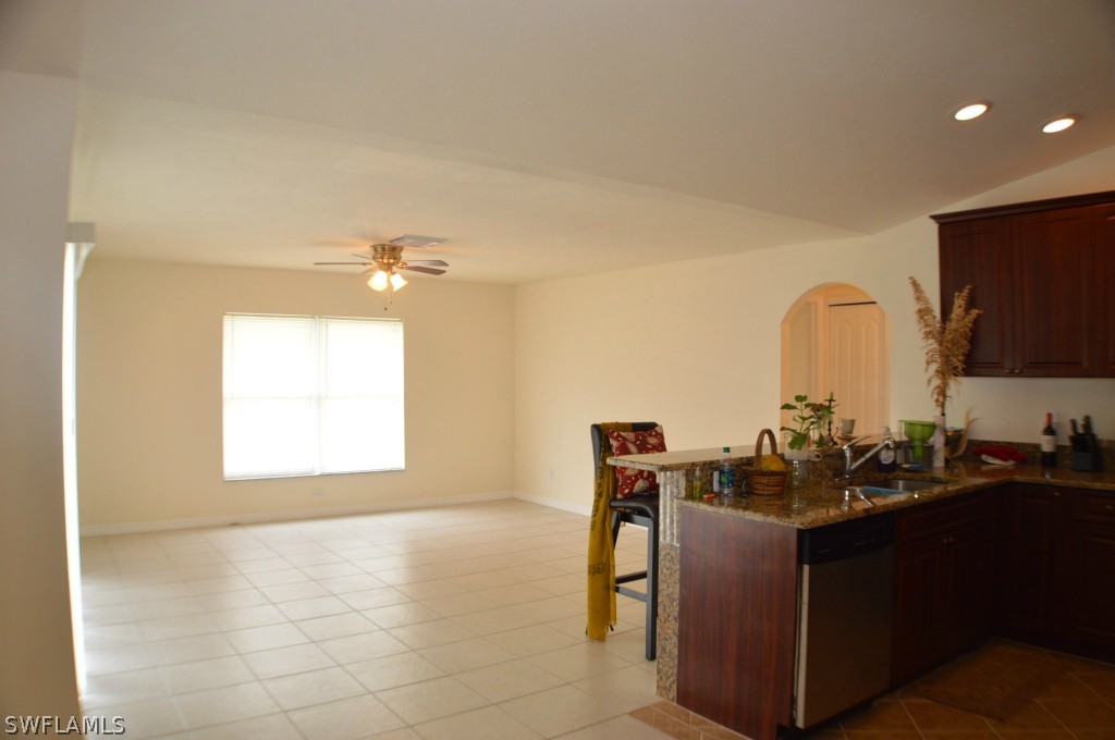 134 Ridgemont Drive Lehigh Acres, FL 33972 - Photo 6 of 14 a kitchen with a sink and cabinets