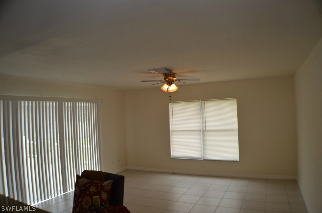 134 Ridgemont Drive Lehigh Acres, FL 33972 - Photo 7 of 14 a view of a livingroom with a ceiling fan and window