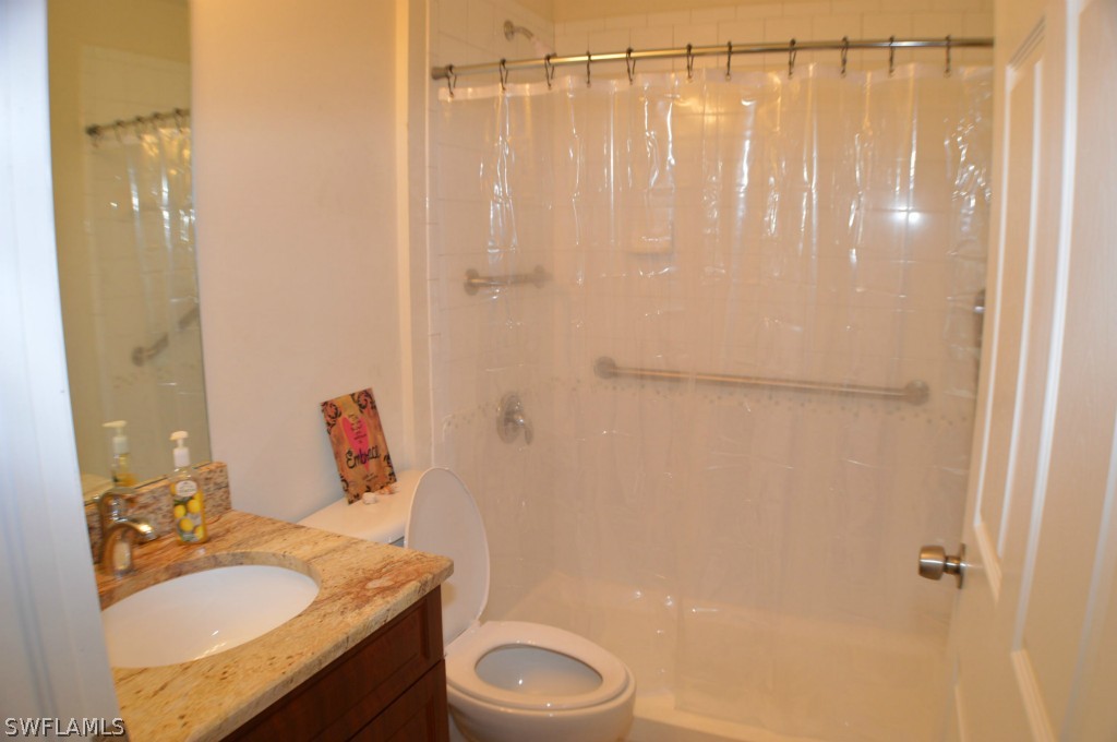 134 Ridgemont Drive Lehigh Acres, FL 33972 - Photo 10 of 14 a bathroom with a granite countertop sink toilet and shower