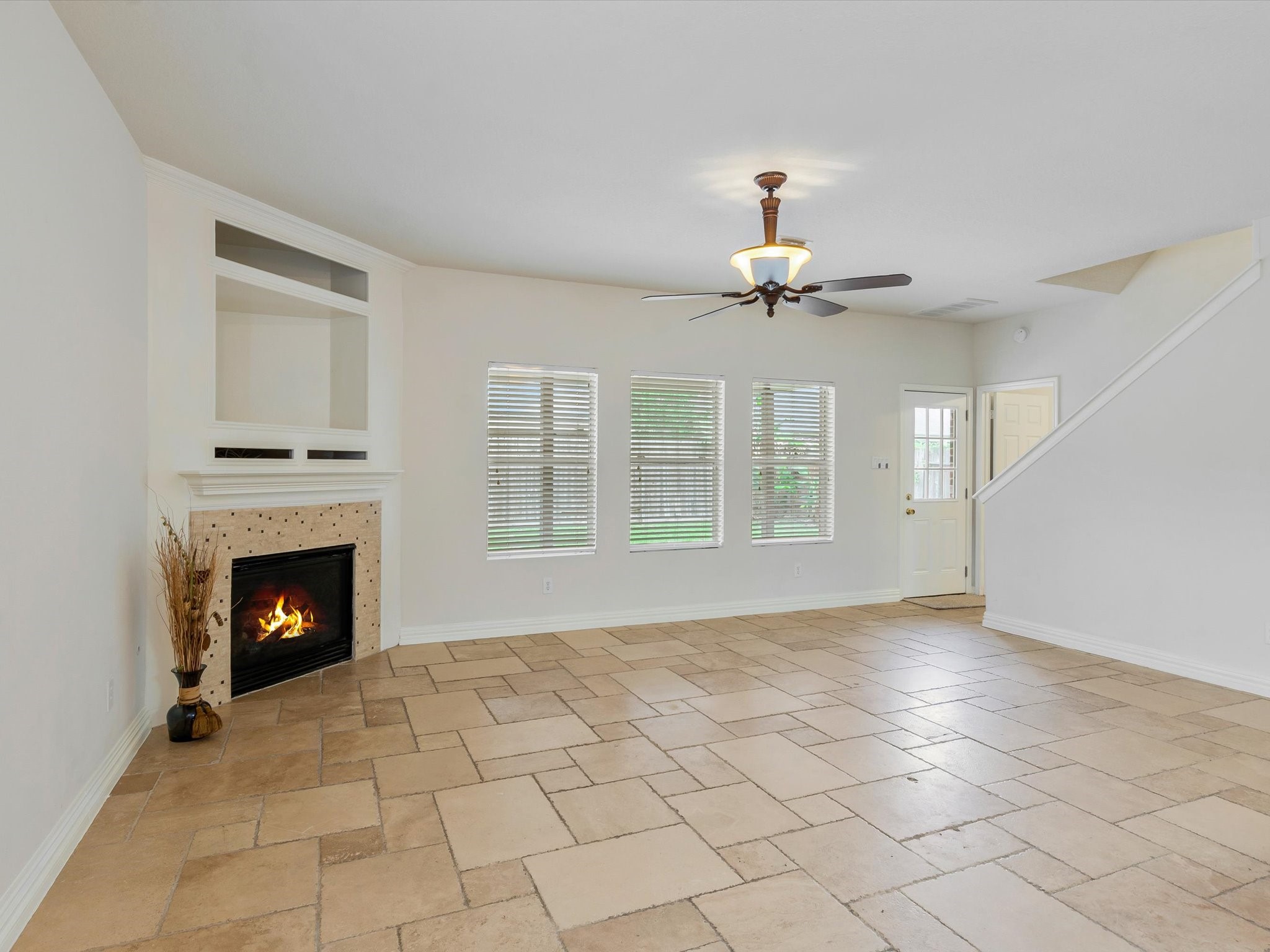 19422 Harvest Stream Way Houston, TX 77084 - Photo 5 of 41 This living area features large windows for natural light and elegant tile flooring.