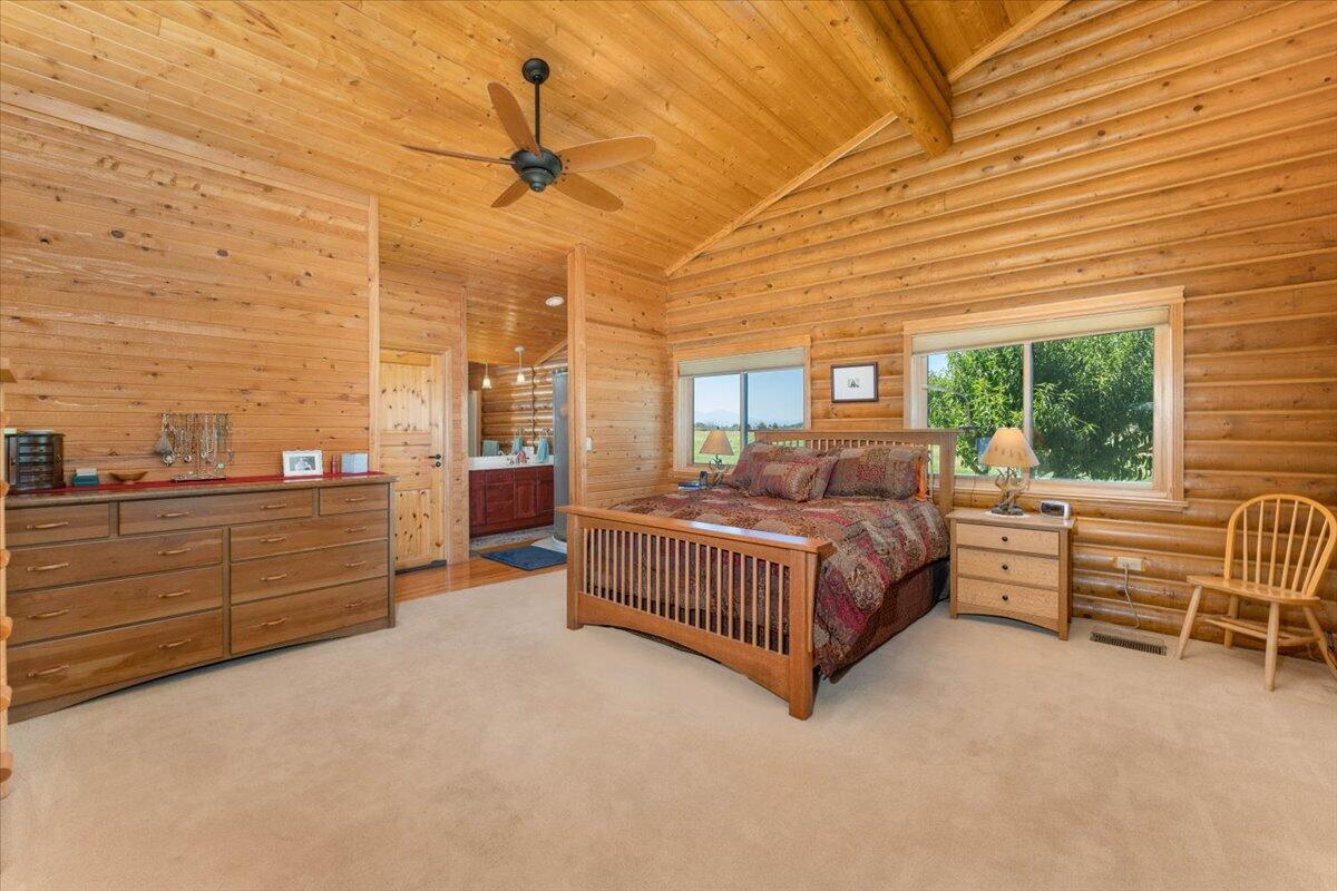 4208 Balls Ferry Road Cottonwood, CA 96022 - Photo 13 of 53 a spacious bedroom with a bed and large windows