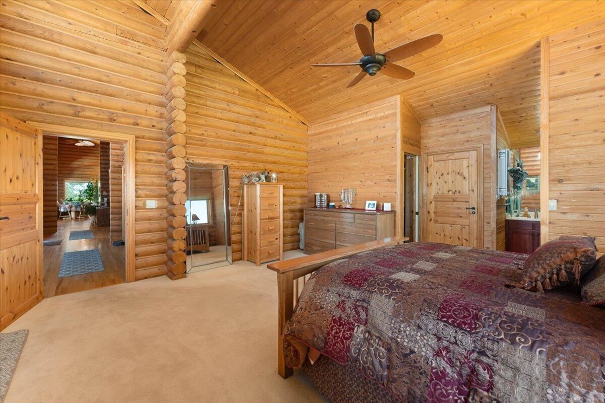 4208 Balls Ferry Road Cottonwood, CA 96022 - Photo 14 of 53 a bedroom with a bed and a chandelier