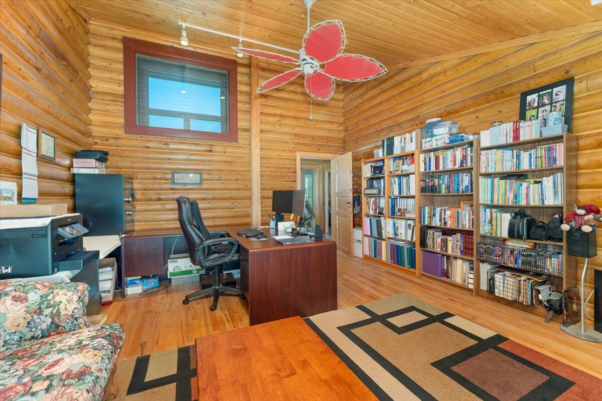 4208 Balls Ferry Road Cottonwood, CA 96022 - Photo 22 of 53 a view of a dining room with furniture and a book shelf