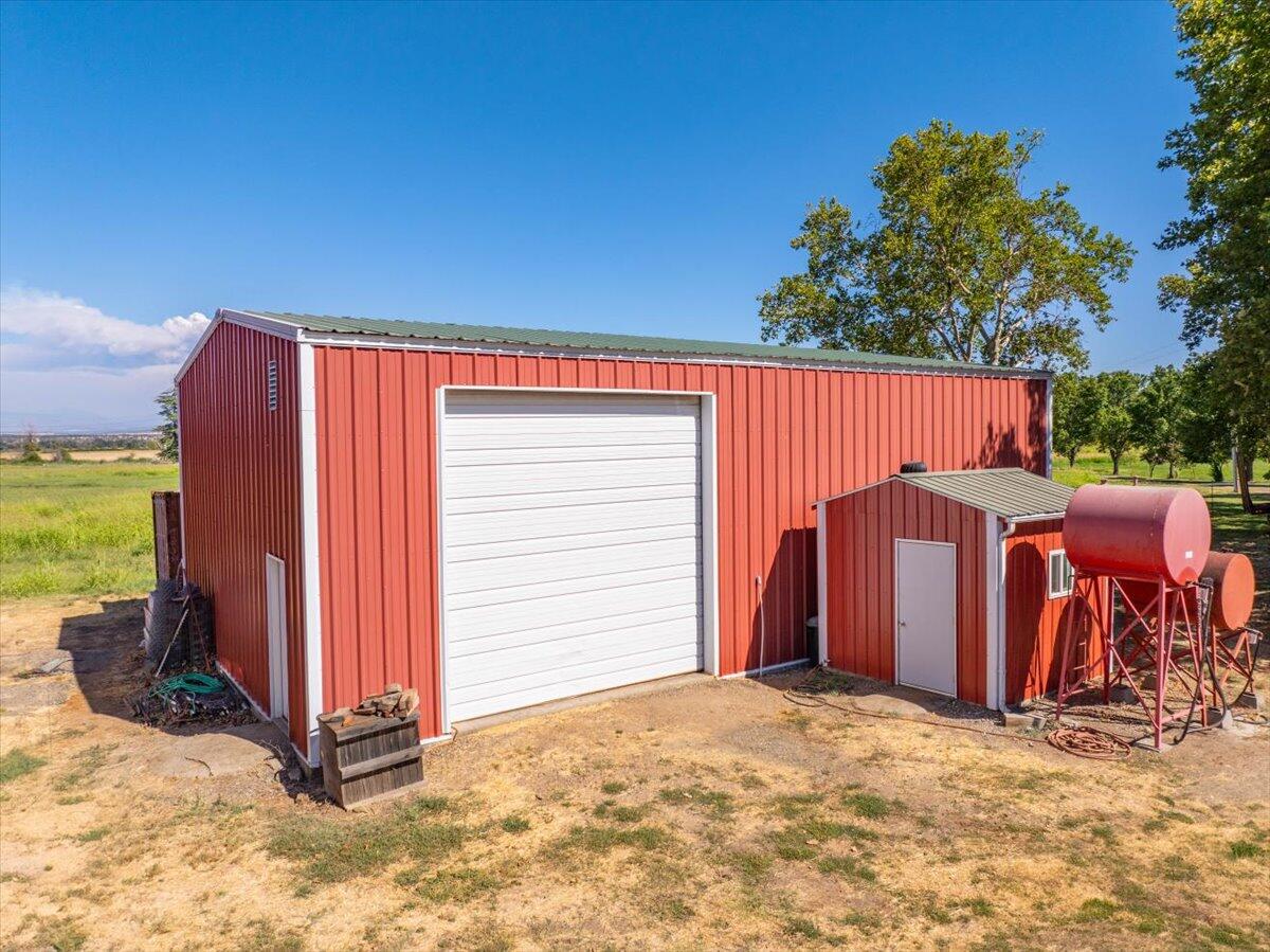 4208 Balls Ferry Road Cottonwood, CA 96022 - Photo 45 of 53 a view of a backyard with chairs and a stove