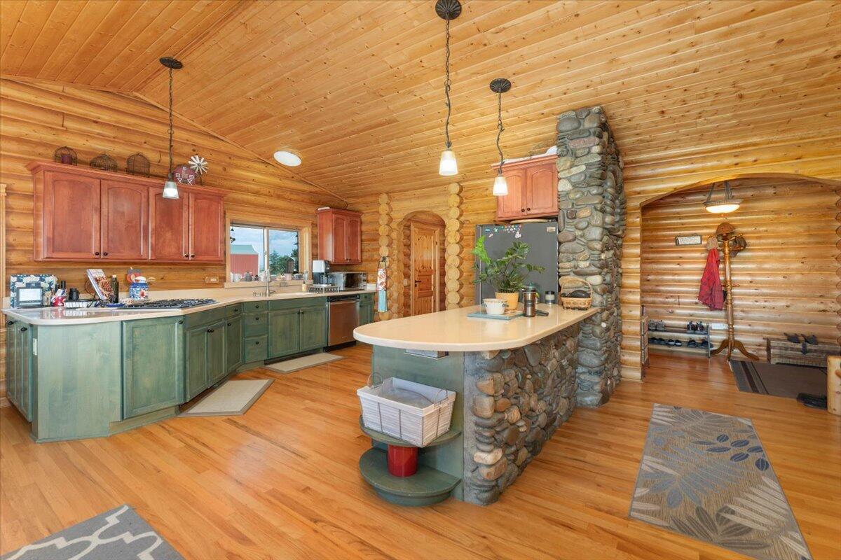4208 Balls Ferry Road Cottonwood, CA 96022 - Photo 6 of 53 a kitchen with kitchen island a sink a stove and a wooden floors