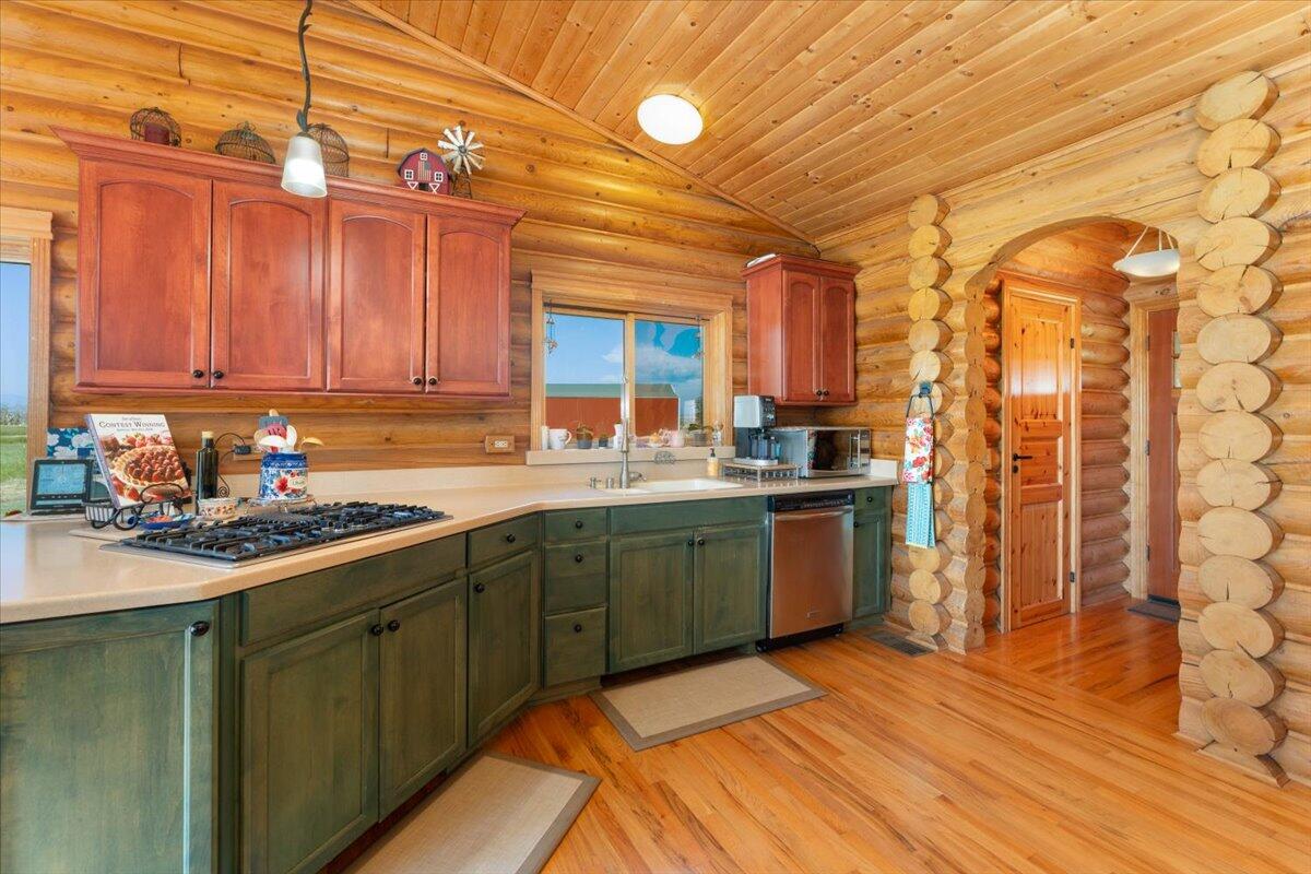 4208 Balls Ferry Road Cottonwood, CA 96022 - Photo 7 of 53 a kitchen with a sink cabinets and wooden floor