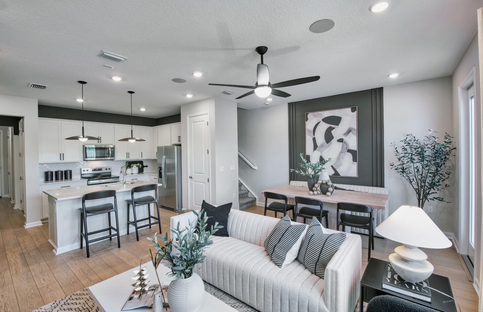 288 Southwest Sally Way, Unit LATITUDE 6112 Stuart, FL 34997 - Photo 7 of 22 a living room with furniture kitchen view and a chandelier