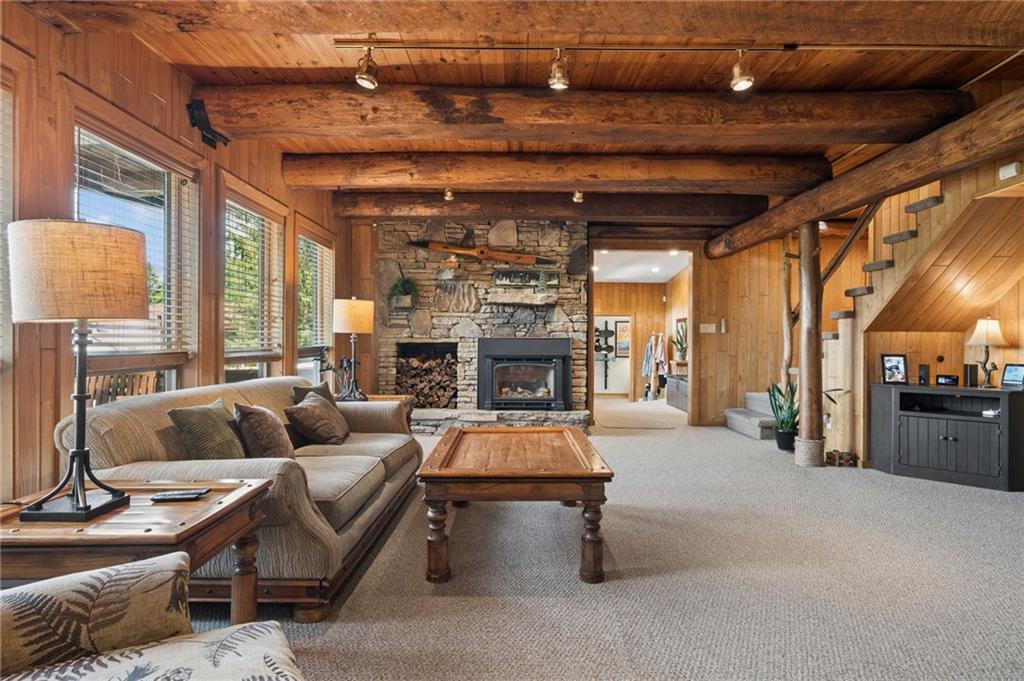 2488 County Line Road Champion, PA 15622 - Photo 8 of 39 Living room with views of North Face Slopes & Cedar beams from the resort, Stone gas fireplace
