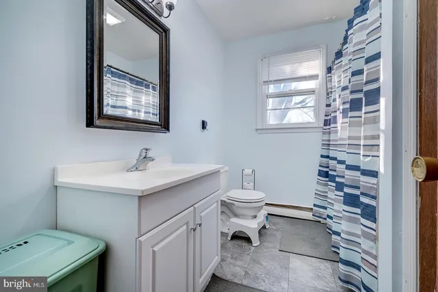 a bathroom with a sink toilet and mirror