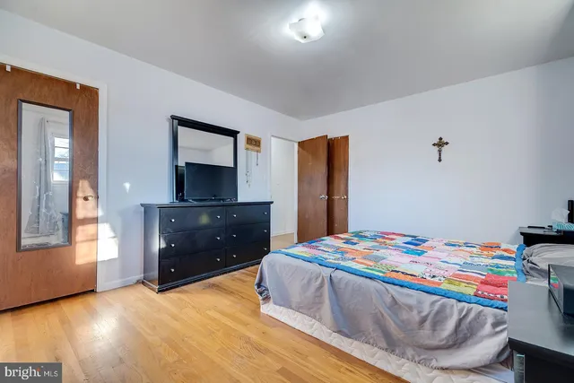 a bedroom with a bed and a dresser