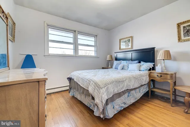 a bedroom with a bed and a night stand