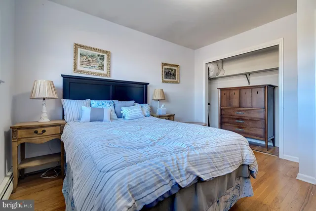a bedroom with a bed and a view of kitchen