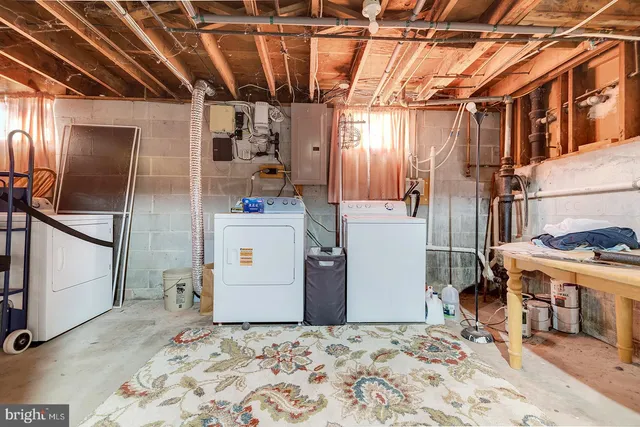 a view of a refrigerator in kitchen and a living room