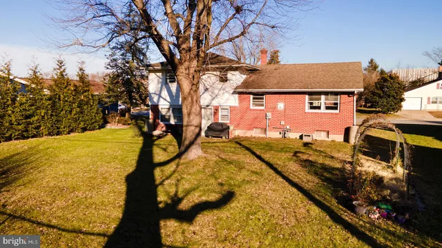 a view of a house with a yard covered with snow