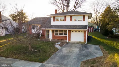 a front view of a house with a garden and yard