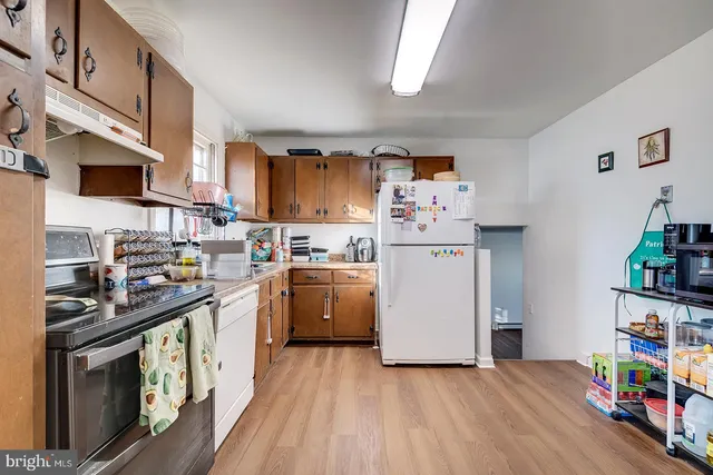 a kitchen with stainless steel appliances a stove a sink and a refrigerator