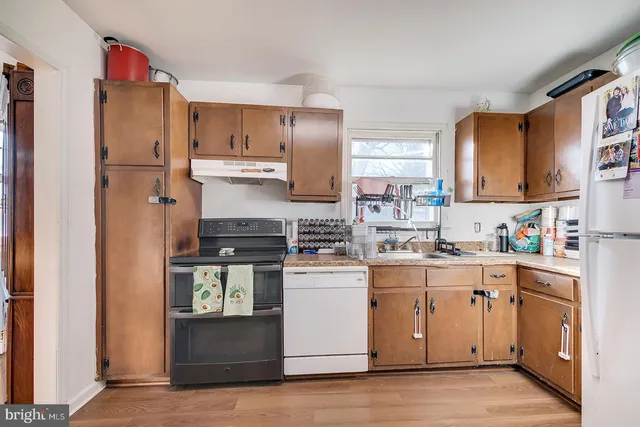 a kitchen with stainless steel appliances white cabinets and a refrigerator