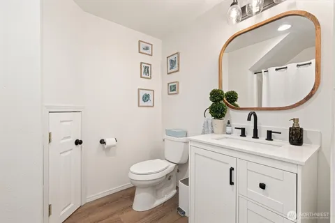 a bathroom with a sink a toilet and a mirror