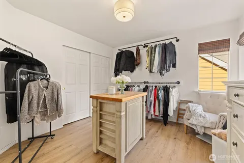 a view of walk in closet with clothes and shoes