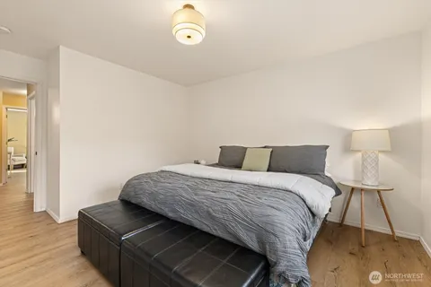 a bedroom with a bed and a lamp on table