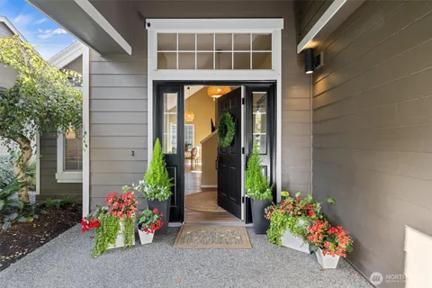 a vase of flowers sitting in front of a door