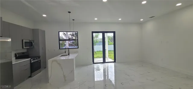 a view of a kitchen with furniture and natural light