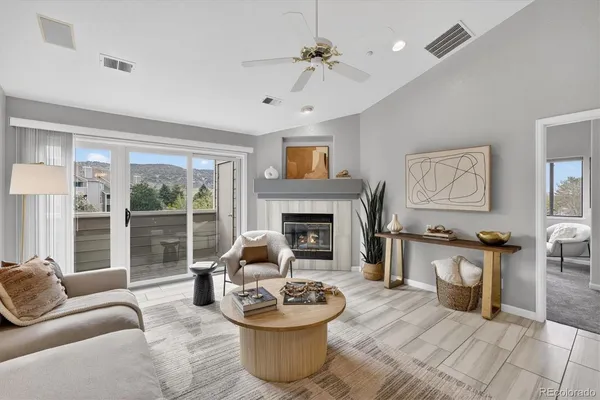 a living room with furniture and a fireplace