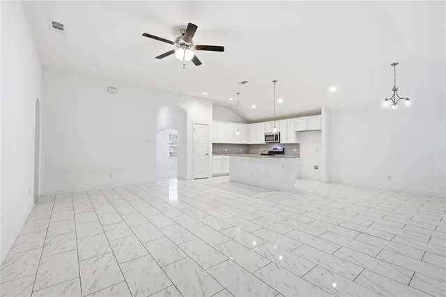 a view of a kitchen with furniture and a ceiling fan