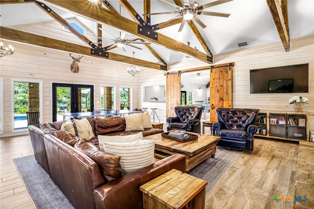 871 Chimney Valley Road Blanco, TX 78606 - Photo 16 of 45 a living room with furniture and a flat screen tv