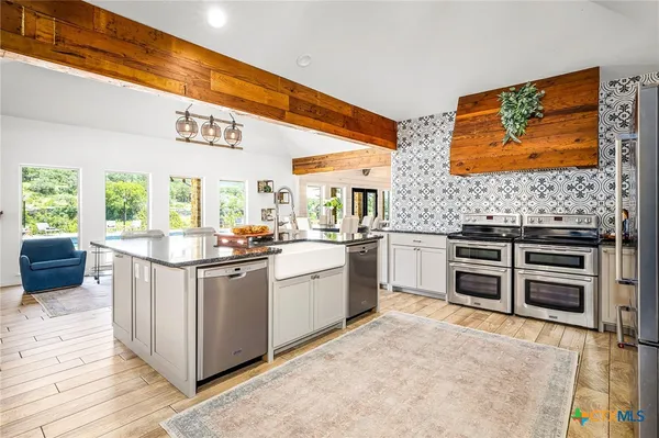 a kitchen with stainless steel appliances and white cabinets