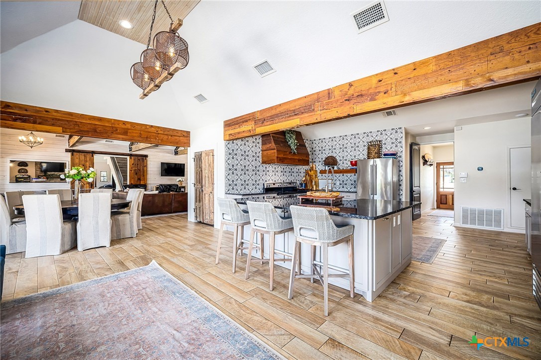 871 Chimney Valley Road Blanco, TX 78606 - Photo 19 of 45 a living room with stainless steel appliances kitchen island granite countertop furniture and a view of kitchen