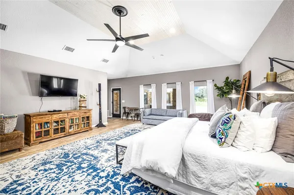 a bedroom with furniture and a flat screen tv